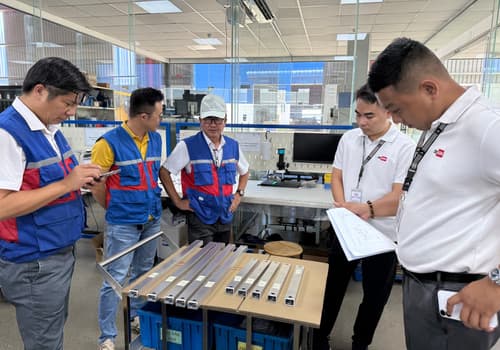 DEWIN and factory team inspecting sample parts at a Vietnam factory