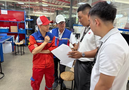 DEWIN engineers reviewing inspection documents with factory staff