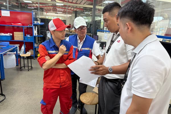 DEWIN engineers reviewing production documents with factory staff