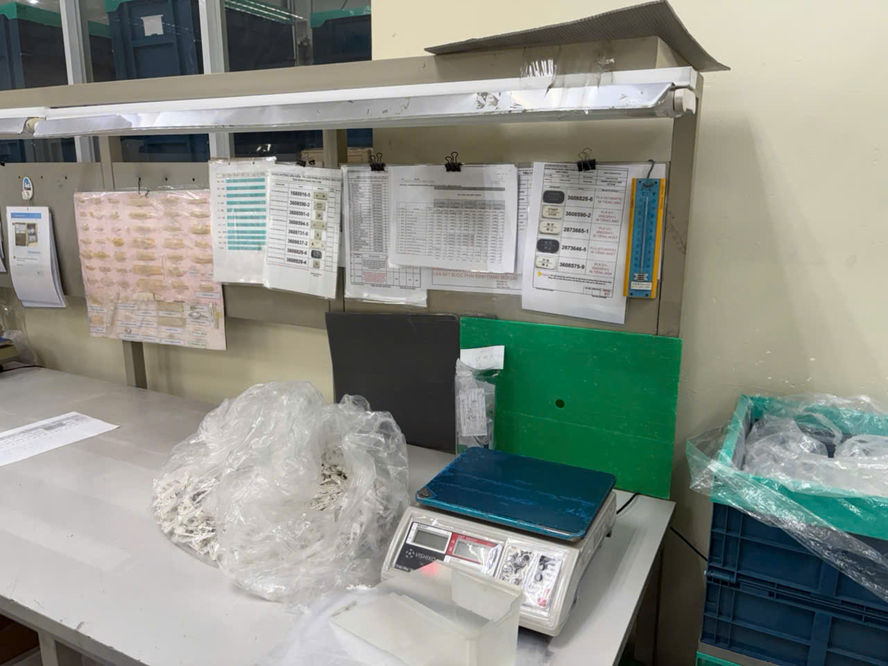 Quality inspection table at Vietnam plastic parts factory with measurement tools